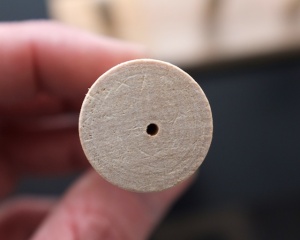 The hole drilled in the bottom to hold the doll on the nail.